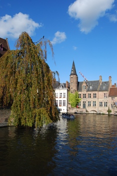 This photo depicts a canalboat wending its way along the canal in Bruges, Belgium ... photo by Patrick Strijards from the Netherlands.